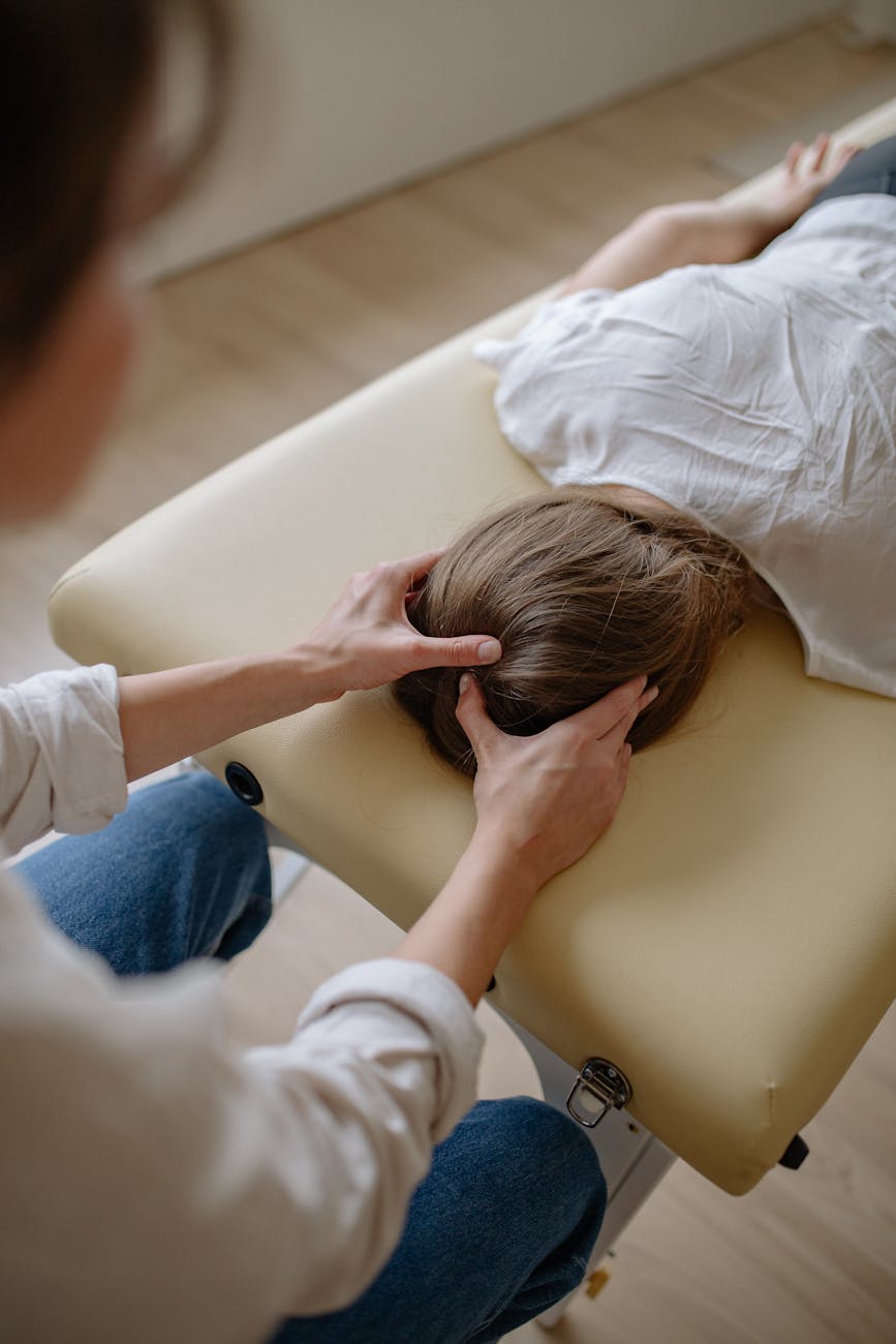 a woman massaging another woman s head